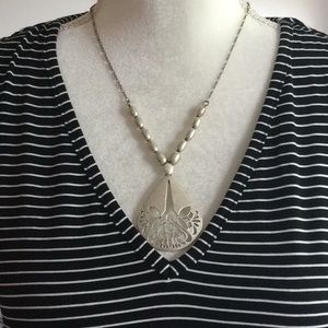 Silver tone lotus design necklace